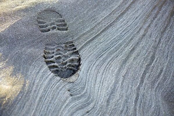 Bootprint and sand patterns at low tide
