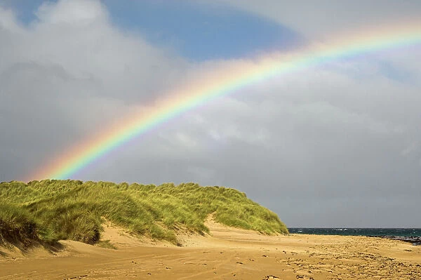 Rainbow over sand dunes