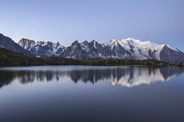 The Mont Blanc mountain range reflected in the waters of Lac de Chesery at sunrise