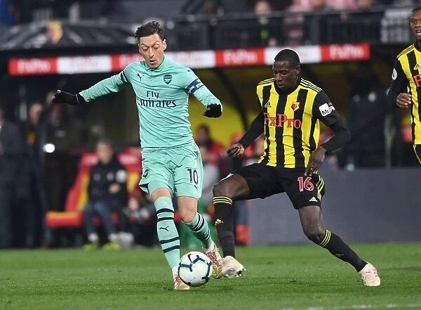 Mesut Ozil vs Abdoulaye Doucoure: A Premier League Showdown at Vicarage Road