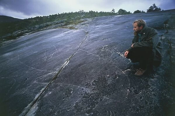 Norway, Nordland County, Tysfjor, prehistoric graffito representing killer whale, beside it, archaeologist Lars Borge Myklevold