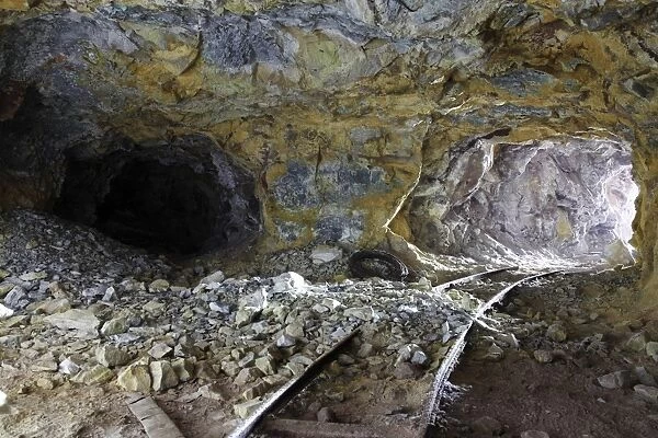 Tunnel with abandoned railtracks at historic sulfur mine, Milos, Greece