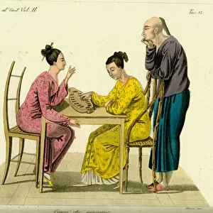Two Chinese women playing the game of congkak