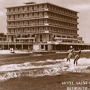 Couple water skiing passed the Hotel Saint Georges, Beirut