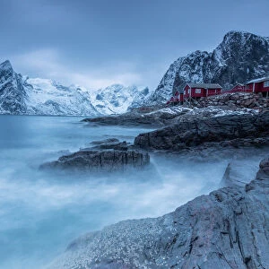 Dusk light on the typical red houses and rough sea, Hamnoy, Lofoten Islands, Northern Norway