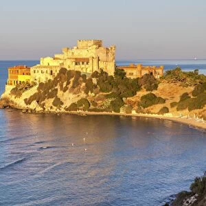 Sunrise on turquoise sea frames the medieval Falconara Castle, Butera, Province of Caltanissetta