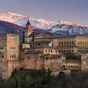 View at sunset of Alhambra palace with the snowy Sierra Nevada in the background