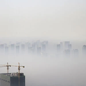 A building under construction is seen amidst smog on a polluted day in Shenyang