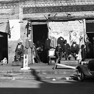 ALABAMA: BOOTBLACKS, 1935. African American bootblacks in front of a shoeshop in Selma, Alabama