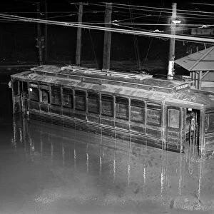 FLOOD, 1923. A flooded trolley car. Photograph, 30 April 1923
