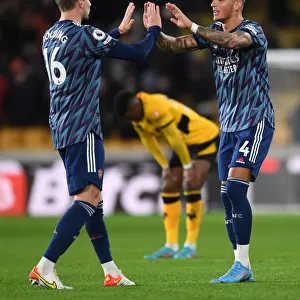 Arsenal's Holding and White Celebrate Victory Over Wolverhampton Wanderers in Premier League