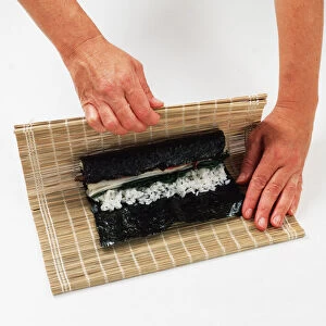2 - Use the mat to help roll the nori round the rice