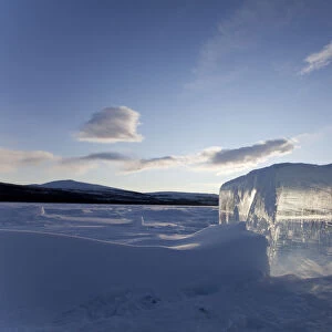 Clear ice cube on frozen Fish Lake, cut out with a chain saw, Yukon Territory, Canada
