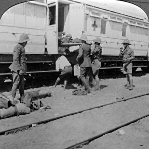 Lifting wounded soldiers onto a hospital train, East Africa, World War I, 1914-1918. Artist: Realistic Travels Publishers