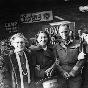Bombardier M. Simons of Cardiff pictured with his wife and mother after his return